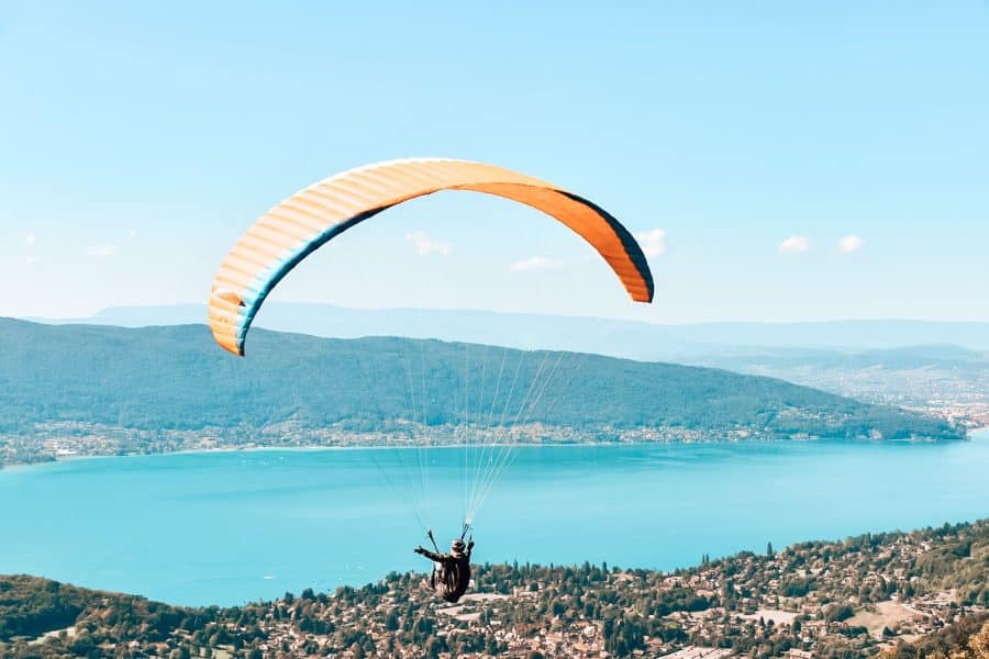 Paragliding over the piercing blue Lake Annecy is one of the top things to do in Annecy for amazing views over the surrounding area