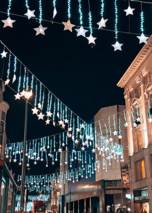 Twinkly stars hanging between the shops along Oxford Street, Christmas lights in London