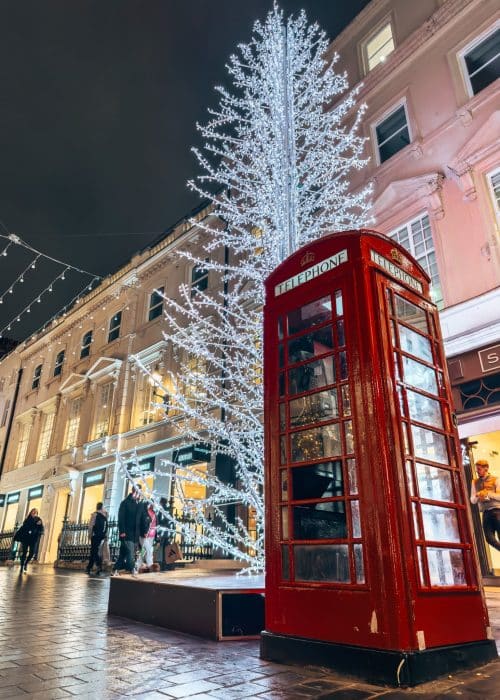 A white Christmas tree next to a red telephone box, South Molten Street Christmas Lights, Mayfair, London