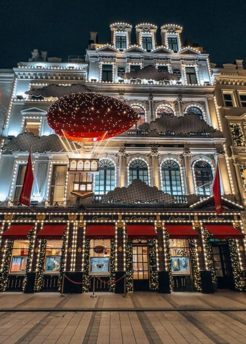 A giant red hot air balloon on Cartier's storefront, London at Christmas 2024