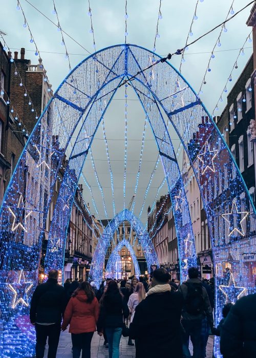 Big blue arches of sparking lights with stars on South Molten Street has some of the top Christmas Lights in London, Mayfair