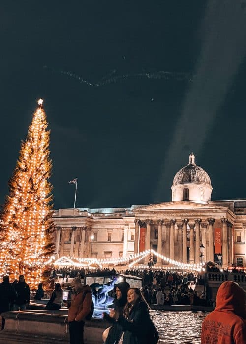 The Trafalgar Square Christmas Tree in front of the National Gallery with Christmas market stalls below, London