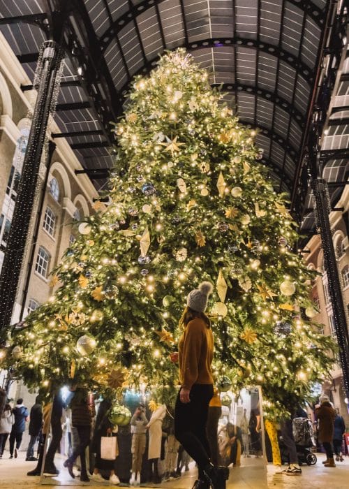 Helen stood in front of a massive Christmas tree in Hay's Galleria at Christmas by the River, London