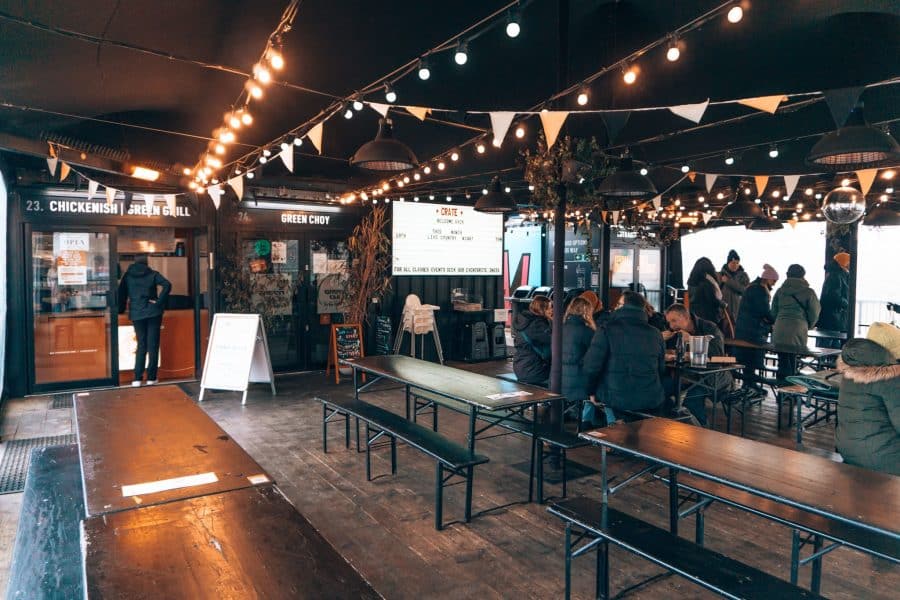 The large terrace at CRATE St James with twinkly lights, long tables and numerous street food stalls, East London