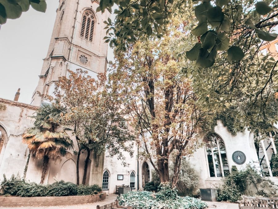 St Dunstan in the East Church's Wren tower in the gardens surrounded by greenery, London