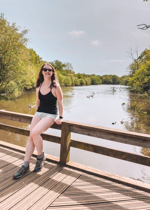 Helen perched on a bridge overlooking the lake at Connaught Water, Epping Forest, London