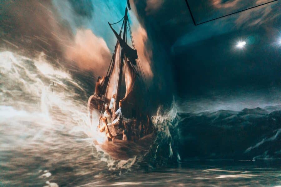 A ship on a stormy sea being pounded by waves in Rembrandt van Rijn's Christ in the Storm on the Lake of Galilee in The World Around Us gallery at Frameless London