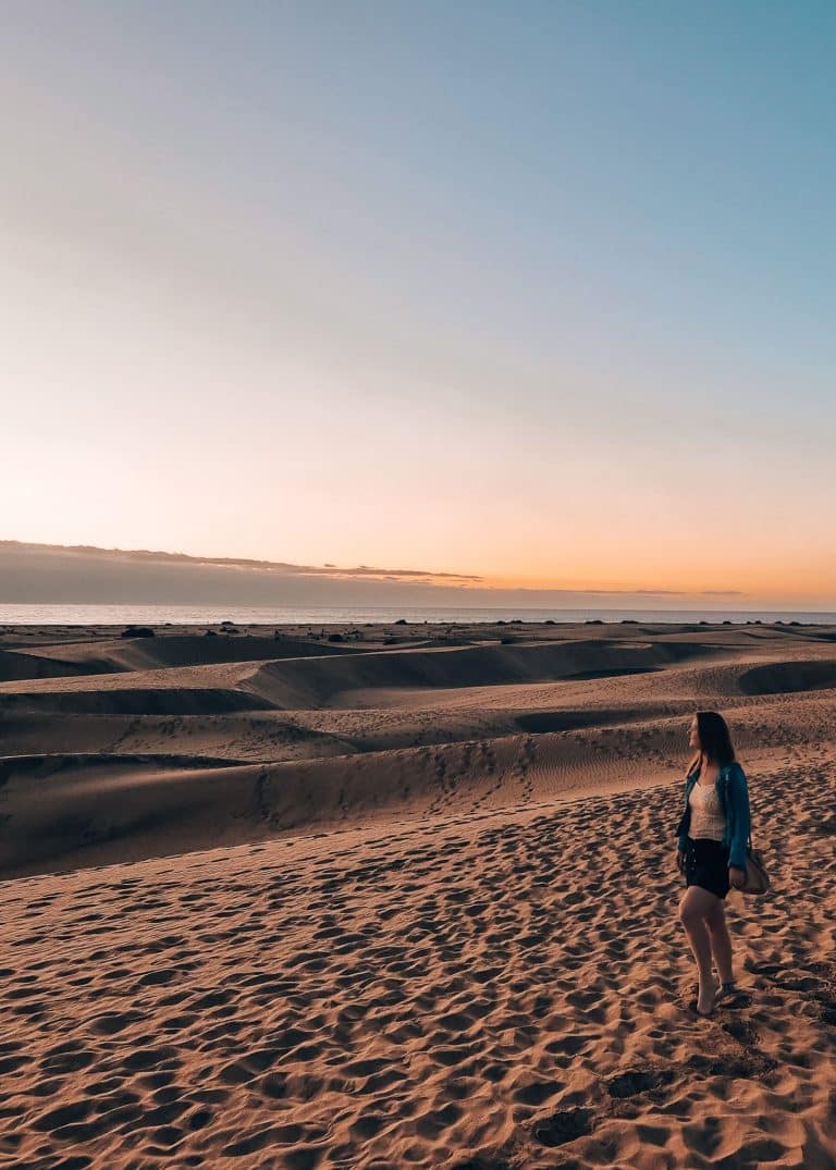 Helen standing on the Dunas de Maspalomas watching the sunrise is one of the best things to do in Gran Canaria