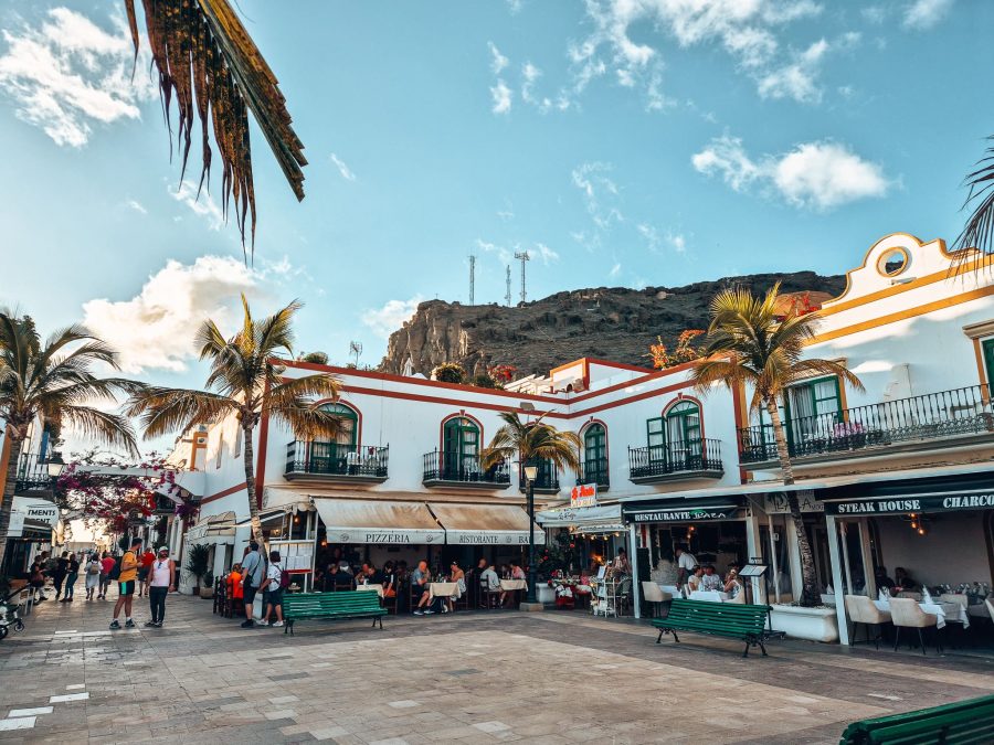 A plaza in the Old Town of Puerto de Mogan with quaint restaurants with outside seating, Gran Canaria itinerary, Spain