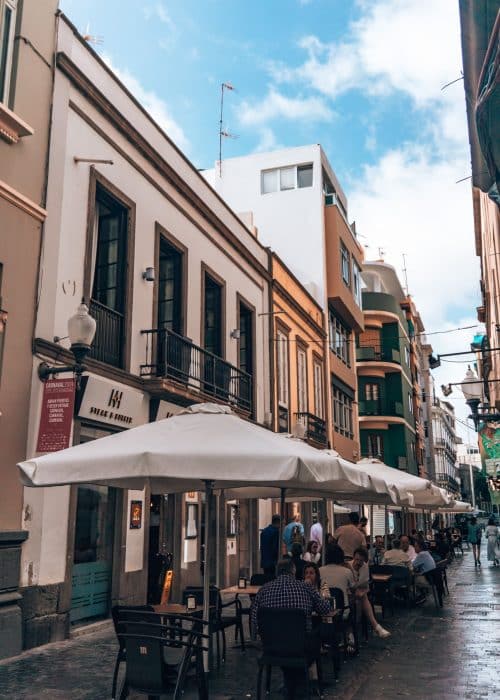 A narrow picturesque street in Triana with outdoor seating from restaurants and people socialising, Las Palmas, Gran Canaria