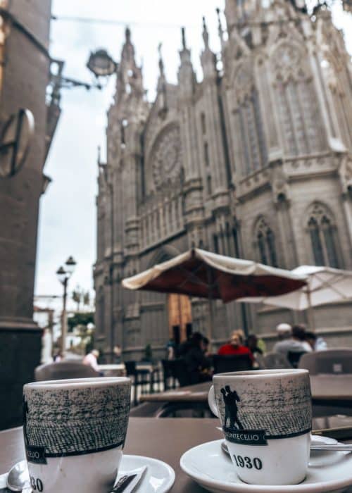 Two cups of coffee on a table in front of the magnificent San Juan Bautista de Arucas, Gran Canaria