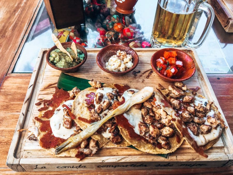 A board of corn tacos with chicken, sauce and various dips, Mexico