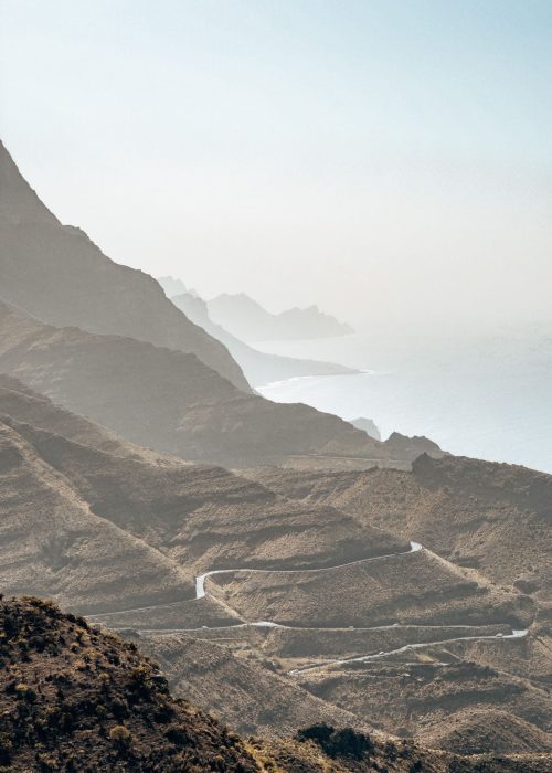 Windy roads hugging the coastline next to huge cliffs plunging into the ocean in the Tamadaba National Park, Gran Canaria