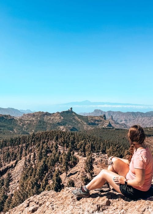 Helen gazing out from the summit of Pico de las Nieves over vast mountains to Roque Nublo and Mount Tiede, Tejeda, Gran Canaria