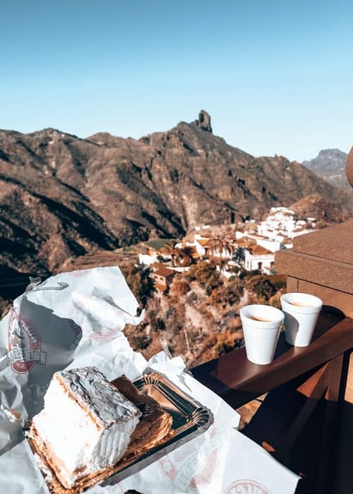 Having pastries and coffees from Dulceria Nublo at the viewpoint overlooking white-washed houses with red roofs and dramatic rock formations is one of the best things to do in Gran Canaria, Canary Islands, Spain