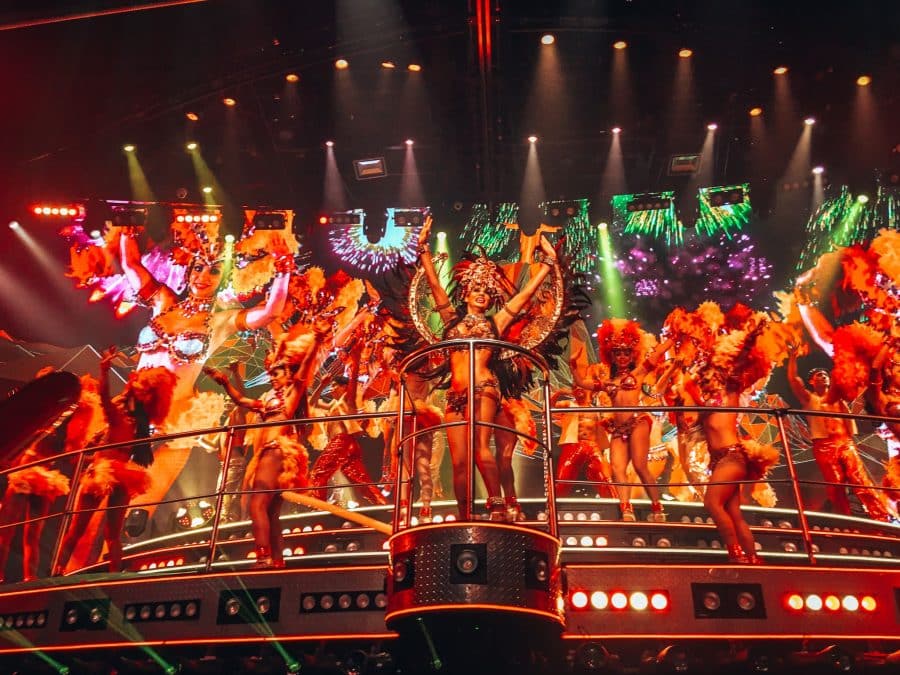 Dancers in colourful outfits performing on stage at Coco Bongo in Cancun; one of the top places to visit in Mexico