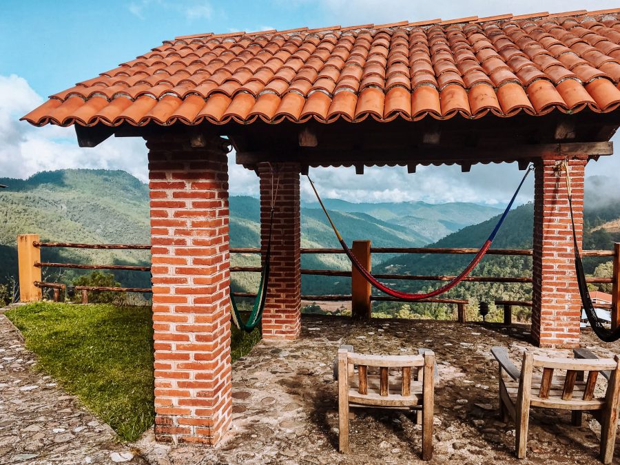 A shelter with a hammock overlooking the vast Pueblos Mancomunados and surrounding mountains, Oaxaca, Mexico