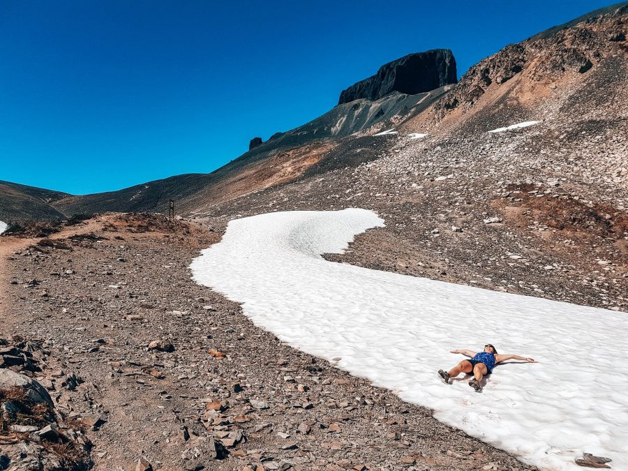 Helen lying in snow to cool off on the way up to Black Tusk, Garibaldi Provincial Park, Whistler