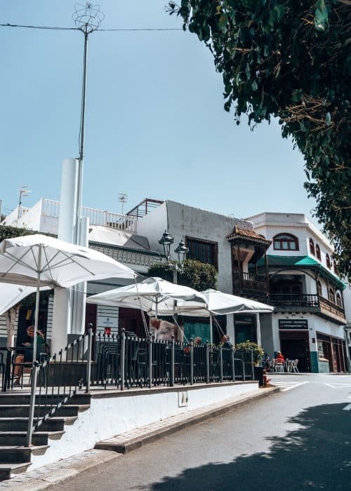 White-washed buildings with cafes with outdoor seating in Agaete, one of the best places to visit in Gran Canaria