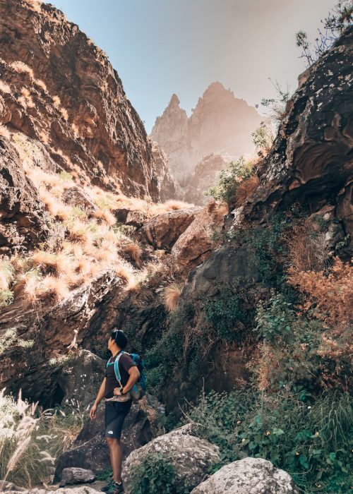 Andy stood at the bottom of dramatic jagged peaks in the Tamadaba National Park, Puerto de las Nieves, Gran Canaria, Spain