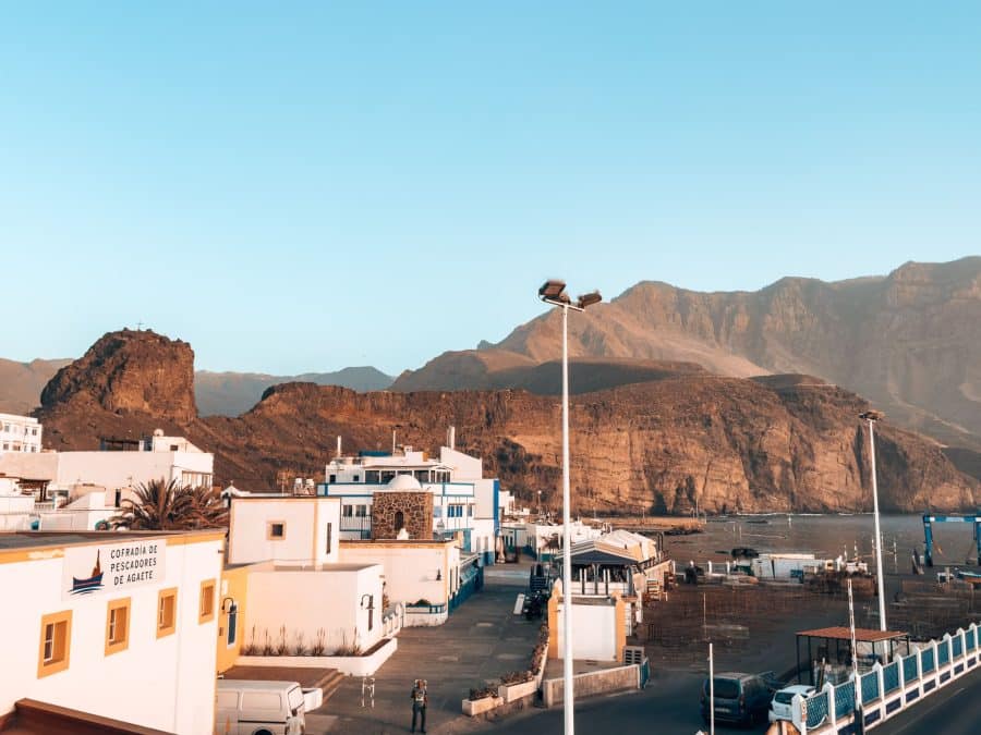 The town of Puerto de las Nieves nestled at the foothills of dramatic mountain peaks in the Tamadaba National Park one of the best places to visit in Gran Canaria