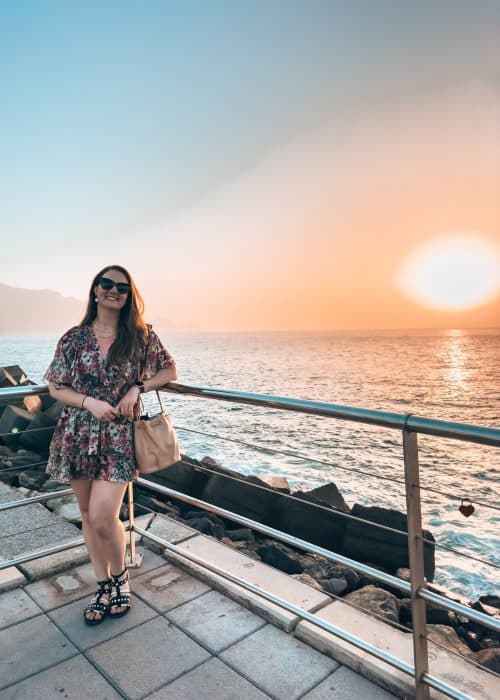 Helen stood on the promenade in Puerto de las Nieves with the sun setting into the ocean behind, Gran Canaria