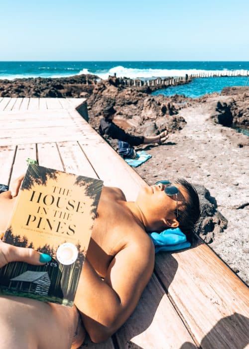 Andy sunbathing on a deck and Helen reading a book at Las Salinas de Agaete, Puerto de las Nieves, Gran Canaria, Spain