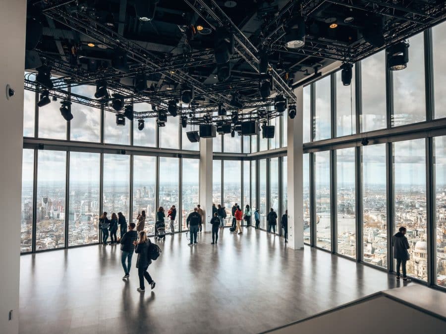 A big room with floor-to-ceiling glass windows looking out over the London skyline at the Horizon 22 Viewing Platform, one of the best free viewpoints in London