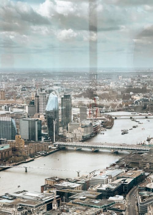 View across West London over Millennium Bridge to the London Eye, Hyde Park, Big Ben and Westminster from Horizon 22 London