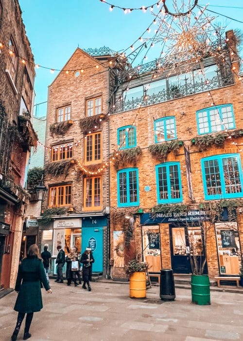 A large building with bright orange and blue window frames in Neal's Yard, one of the most colourful places in London