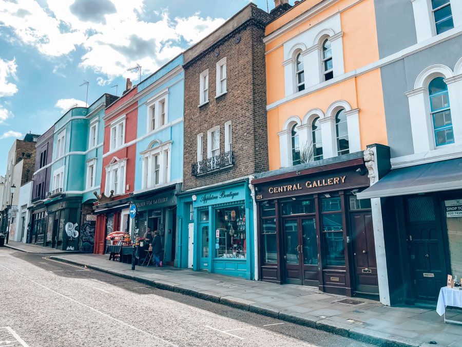 A row of terraced shops with colourful upper floors on Portobello Road, one of the most famous streets in London