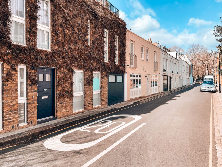 Peach coloured terrace houses with foliage on the front Pottery Lane, Notting Hill, London