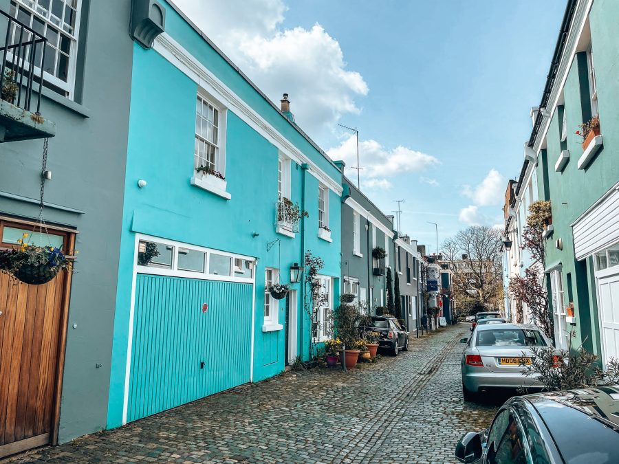 A narrow street of bright blue and green terraced houses, Norland Place, Notting Hill, London