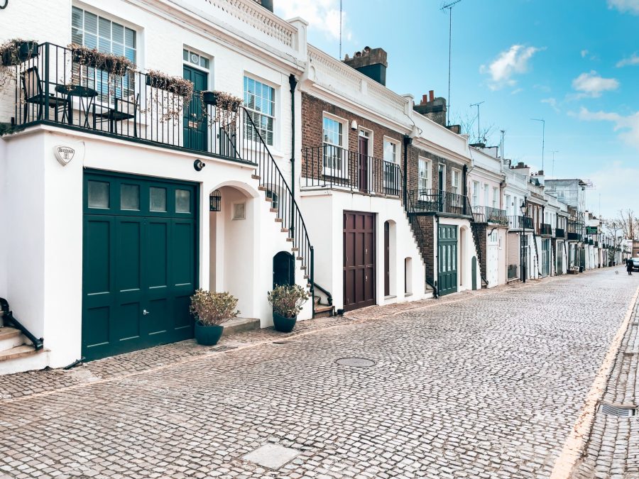 The elegant Holland Park Mews with simple and muted coloured garage and main front doors, Notting Hill, London