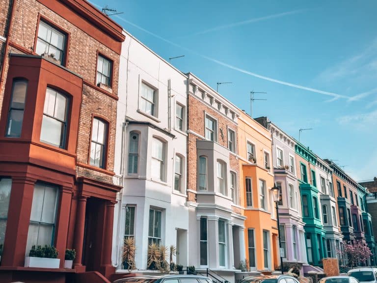 A row of bold-coloured terraced houses on Lancaster Road, Notting Hill, Most Famous Streets in London