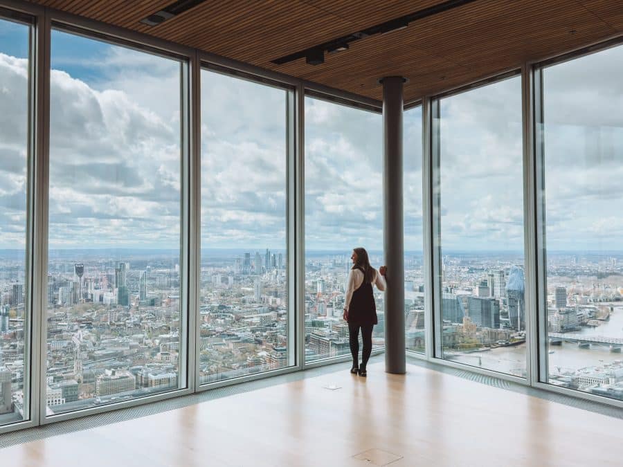 Helen stood next to floor-to-ceiling glass windows looking at the panoramic views of London at The Lookout