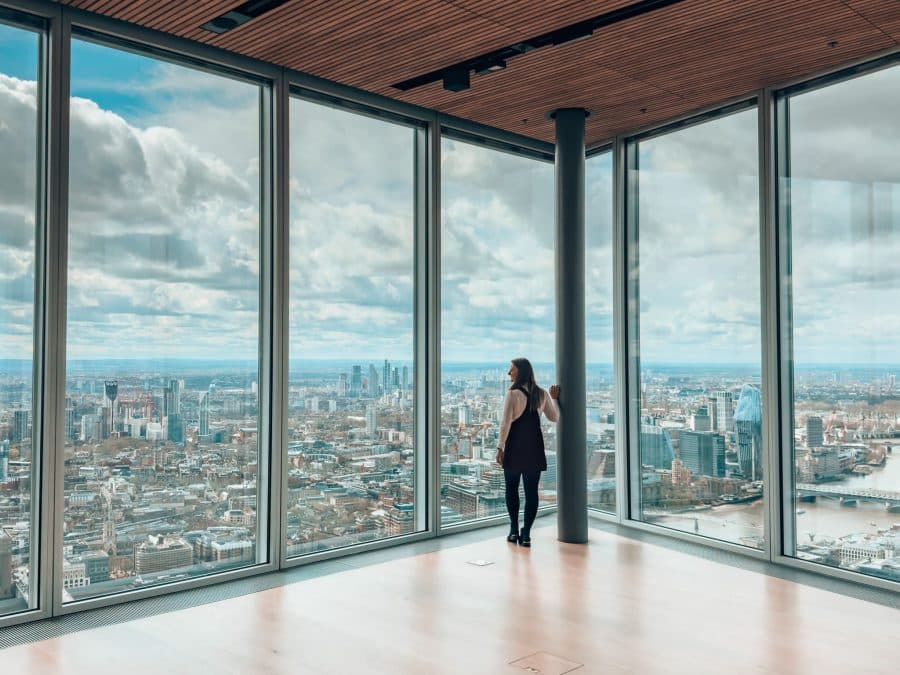 Helen stood next to floor-to-ceiling glass windows looking at the panoramic views of London at The Lookout