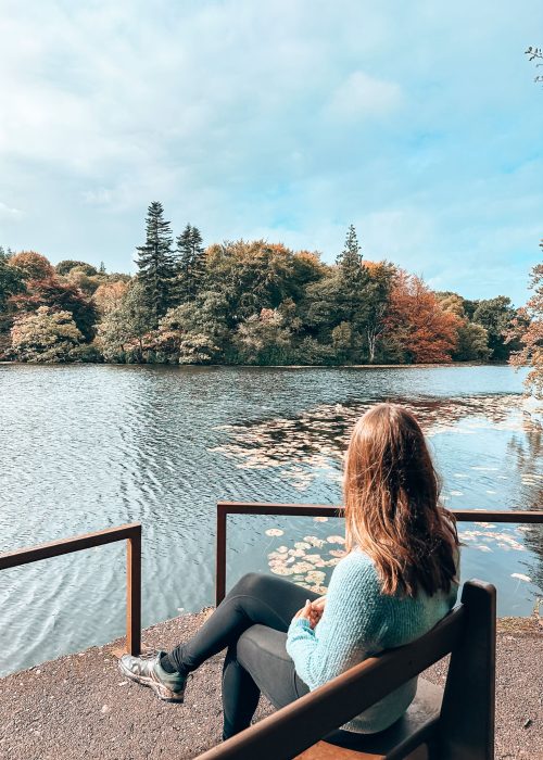 Helen sat on a bench overlooking Lochan a Ghurrabain in Aros Park, Isle of Mull