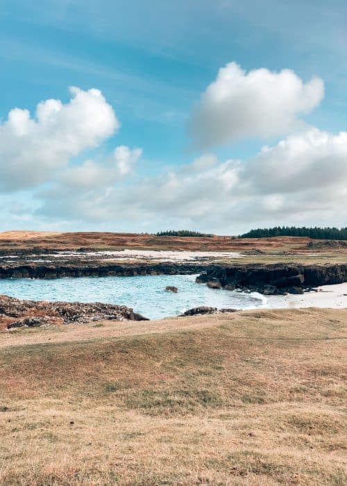 A rugged white sand beach surrounded by countryside, Langamull Beach, places to visit on the Isle of Mull, Scotland