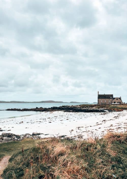 A white sand beach with a lonely house at the other side, Isle of Iona