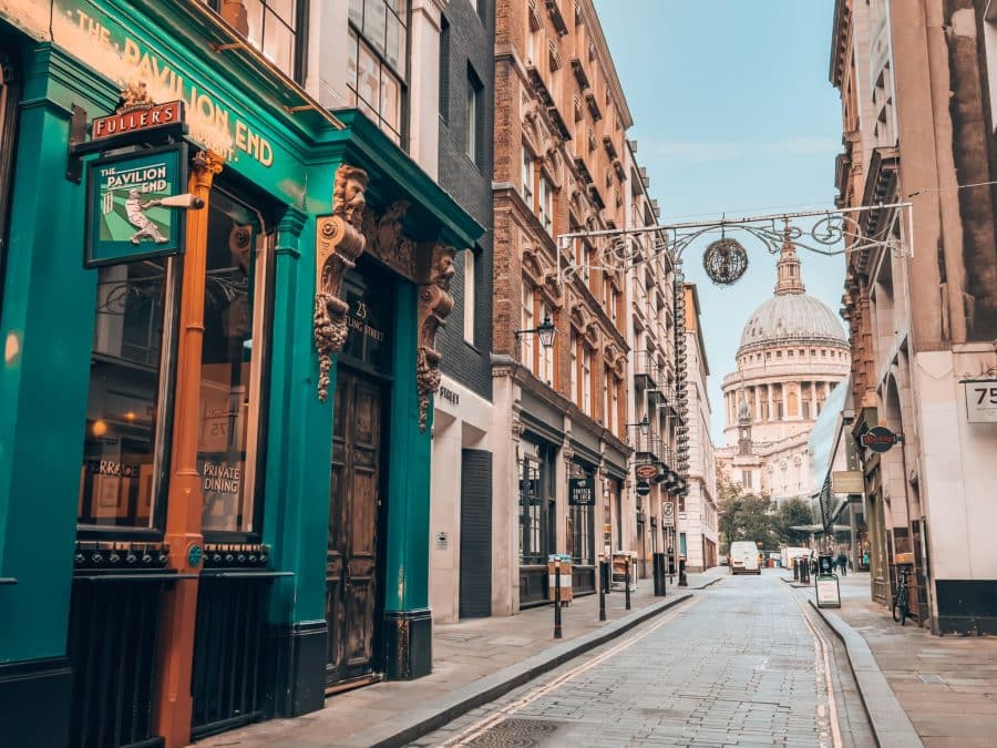 The historical Watling Street with old pubs and shops lining a narrow alley with St Paul's at the end, London