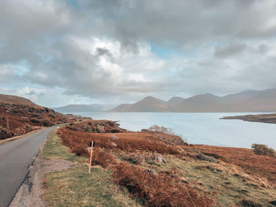 A single-lane road next to the ocean with a mountain backdrop, Isle of Mull itinerary