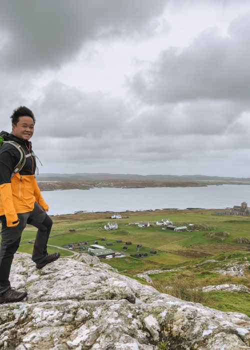 Andy on the peak of Dun I overlooking the Isle of Iona and across the sea to Mull, Scotland