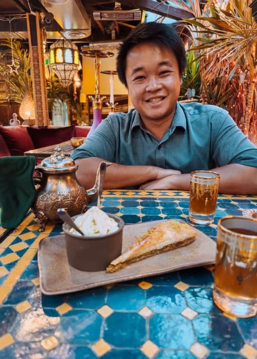 Andy with baklawa and Moroccan mint tea at Oasis Lounge London, best Moroccan restaurants in London