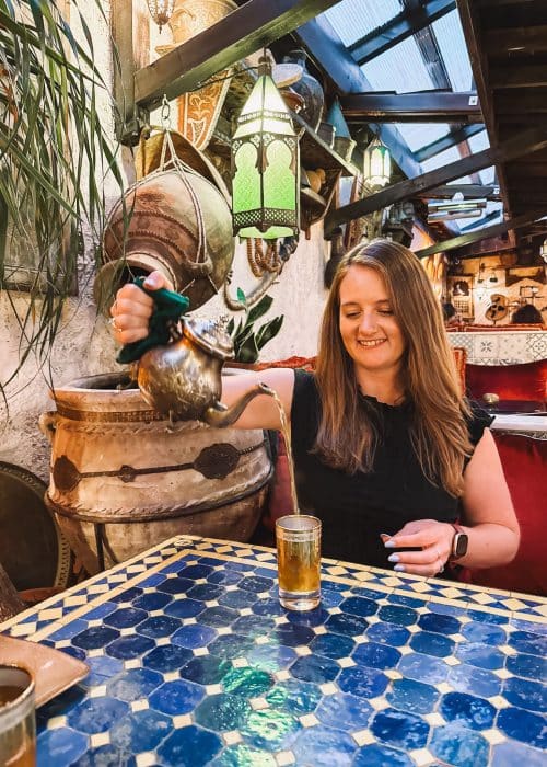 Helen pouring Moroccan mint tea from a tea pot into a glass, Oasis Lounge London, best Moroccan restaurants in London