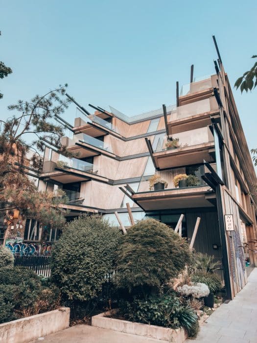 Exterior of the Nobu Hotel London Shoreditch with balconies overlooking greenery