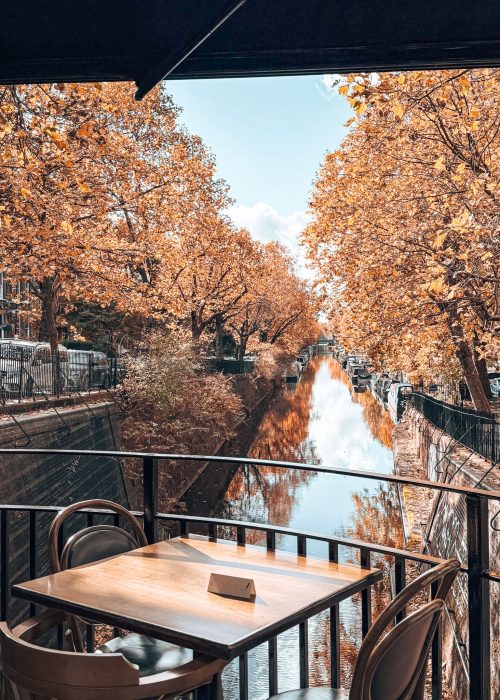 A table on a balcony overlooking Regent's Canal and Little Venice during autumn with golden trees, Cafe Laville, London Itinerary