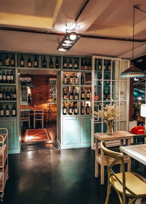 A gorgeous wine bar with bottles lining the walls and atmospheric lighting, Bufe Wine Bar, bars in Tirana, Albania