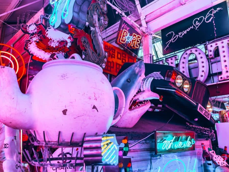 A large teapot, shark and car surrounded by neon art at God's Own Junkyard, Walthamstow, 4 Days in London Itinerary