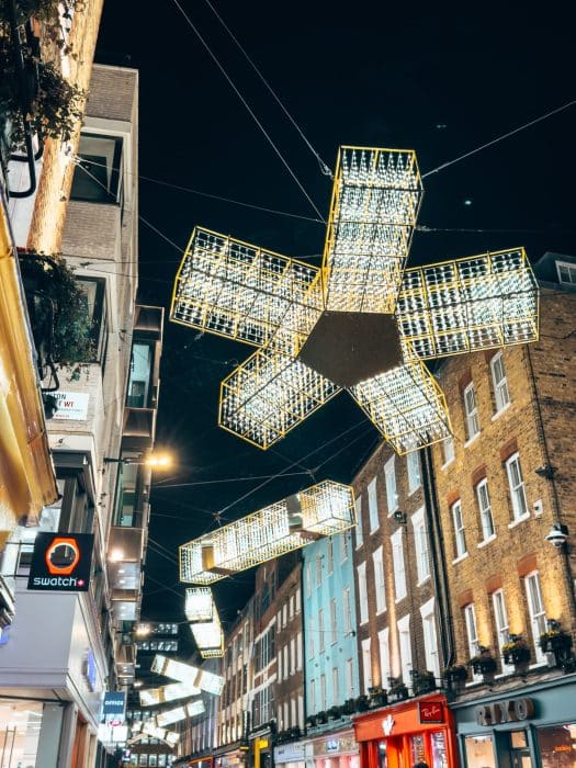 White sparkly ribbons and crackers floating about Carnaby Street at Christmas in London